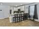 Bright kitchen with white cabinets, a stainless steel refrigerator, and a breakfast bar with seating at 386 Spruce Ivy St, Moncks Corner, SC 29461