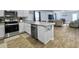 Stylish kitchen with stainless steel appliances, white cabinets, and views of the living room at 386 Spruce Ivy St, Moncks Corner, SC 29461