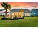 Enjoy outdoor living with a stone fire pit, covered patio, and manicured lawn in the backyard at 467 Hidden Meadow Ln, Summerville, SC 29486