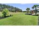 Expansive backyard with a large lawn, patio area, and mature trees, perfect for outdoor activities at 467 Hidden Meadow Ln, Summerville, SC 29486