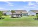 Large backyard featuring lush lawn, patio seating areas, and mature landscaping at 467 Hidden Meadow Ln, Summerville, SC 29486