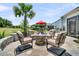 Outdoor patio area featuring a fire pit with seating, a grill and an umbrella-covered dining table at 467 Hidden Meadow Ln, Summerville, SC 29486