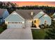 Beautiful home showcasing an expansive driveway and three-car garage, complemented by a lush green lawn at 467 Hidden Meadow Ln, Summerville, SC 29486