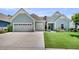 Beautiful home showcasing an expansive driveway and three-car garage, complemented by a lush green lawn at 467 Hidden Meadow Ln, Summerville, SC 29486