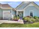 Charming curb appeal with lush landscaping that includes plants and mulch beds at 467 Hidden Meadow Ln, Summerville, SC 29486