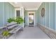 Inviting front porch features a comfortable bench, decorative accents, and a welcoming entrance at 467 Hidden Meadow Ln, Summerville, SC 29486