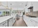 Open concept kitchen with island seating and stainless steel appliances, transitioning to the dining area at 467 Hidden Meadow Ln, Summerville, SC 29486