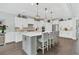 Bright kitchen with white cabinetry, gray island with barstool seating, and pendant lighting at 467 Hidden Meadow Ln, Summerville, SC 29486