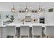 Close-up of the kitchen island featuring a white countertop, sink, and four barstools at 467 Hidden Meadow Ln, Summerville, SC 29486