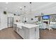 Kitchen featuring a large island with sink, stainless steel appliances, and open view to the living room at 467 Hidden Meadow Ln, Summerville, SC 29486