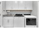 Bright laundry room with granite countertops, ample cabinets, and modern Whirlpool washer and dryer at 467 Hidden Meadow Ln, Summerville, SC 29486