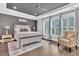 Bedroom featuring tray ceilings, wood floors, and large windows providing natural light at 467 Hidden Meadow Ln, Summerville, SC 29486
