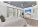 Comfortable bedroom with tray ceiling, decorative ceiling fan, large windows, and ensuite at 467 Hidden Meadow Ln, Summerville, SC 29486