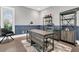 Spacious home office features natural light, dark wood floors, and handsome shelving for storage and decor at 467 Hidden Meadow Ln, Summerville, SC 29486