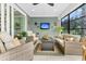The sunroom has a ceiling fan, with wicker furniture and a mounted television for enjoyment at 467 Hidden Meadow Ln, Summerville, SC 29486