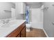 Clean bathroom with a white vanity, commode, and a shower/tub with a floral shower curtain at 4801 Shady Tree Ln, Summerville, SC 29485