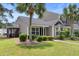 The rear of this house showcases an attractive screened-in porch and lush landscaping at 4801 Shady Tree Ln, Summerville, SC 29485