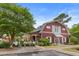 Community clubhouse featuring a barn-style design, well-maintained landscaping, and inviting outdoor recreational spaces at 4801 Shady Tree Ln, Summerville, SC 29485