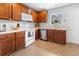 Charming kitchen with wood cabinets, white appliances, and a window letting in natural light at 4801 Shady Tree Ln, Summerville, SC 29485