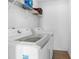 Functional laundry room with modern white washer and dryer and storage shelving at 4801 Shady Tree Ln, Summerville, SC 29485