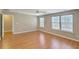 Bedroom featuring a ceiling fan, two windows, and hardwood floors at 4936 Ballantine Dr, Summerville, SC 29485