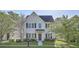 Charming two-story home with traditional architectural details and a well-manicured front yard at 4936 Ballantine Dr, Summerville, SC 29485