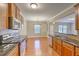 Open kitchen with granite countertops, stainless steel appliances, and hardwood floors at 4936 Ballantine Dr, Summerville, SC 29485