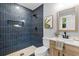 Elegant bathroom with dark blue tiled shower, modern fixtures, and stylish vanity at 4965 Foxwood Dr, North Charleston, SC 29418