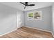 Bright bedroom with wood floors, a ceiling fan, and a window overlooking a well-maintained lawn at 4965 Foxwood Dr, North Charleston, SC 29418