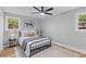 Comfortable bedroom featuring a queen-sized bed, soft carpet, and natural light from two windows at 4965 Foxwood Dr, North Charleston, SC 29418