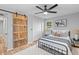This cozy bedroom includes a queen bed, natural lighting, and a sliding barn door at 4965 Foxwood Dr, North Charleston, SC 29418