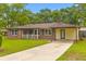 Brick home featuring a covered carport and a welcoming, fenced front porch at 4965 Foxwood Dr, North Charleston, SC 29418