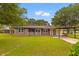 Charming brick home with a well-maintained lawn, carport, and cozy front porch at 4965 Foxwood Dr, North Charleston, SC 29418