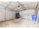 Large garage with ample space, a roll-up door, and storage solutions for vehicles and equipment at 4965 Foxwood Dr, North Charleston, SC 29418