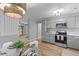 Stylish kitchen with stainless appliances, gray cabinets, and a dining area under a modern chandelier at 4965 Foxwood Dr, North Charleston, SC 29418
