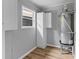 Functional utility room with white cabinets, a window, and a standard water heater at 4965 Foxwood Dr, North Charleston, SC 29418