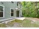 View of the back of the home with siding, windows, and patio, plus a glimpse of the wooded area at 5001 Hay Bale Ct, Summerville, SC 29485