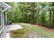 View of the backyard featuring the wooded landscape, patio, and siding of the home at 5001 Hay Bale Ct, Summerville, SC 29485