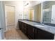 Bathroom with a double sink vanity, granite counters, and a large mirror at 5001 Hay Bale Ct, Summerville, SC 29485