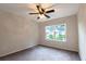 Bedroom featuring a ceiling fan, neutral walls, plush carpeting, and large window at 5001 Hay Bale Ct, Summerville, SC 29485