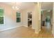 Bright dining room with hardwood floors and a modern chandelier fixture and views into kitchen at 5001 Hay Bale Ct, Summerville, SC 29485