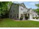 Well-manicured lawn and landscaping enhance this two-story home with attached garage and covered porch at 5001 Hay Bale Ct, Summerville, SC 29485