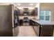 Contemporary kitchen with stainless steel appliances, sleek dark cabinets, and granite countertops for a modern, upscale look at 5001 Hay Bale Ct, Summerville, SC 29485