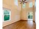 Spacious living room features high ceilings, large windows, and elegant laminate flooring for a clean, modern aesthetic at 5001 Hay Bale Ct, Summerville, SC 29485