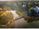 Breathtaking aerial view of the lake, neighborhood, and bridge, nestled among lush trees at 515 Claret Way, Kiawah Island, SC 29455