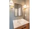 Stylish bathroom vanity featuring a modern sink, black framed mirror and decorative sconce lighting at 515 Claret Way, Kiawah Island, SC 29455