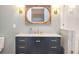 Modern bathroom with a stylish vanity, marble countertop, gold hardware and decoratrive lighting at 515 Claret Way, Kiawah Island, SC 29455