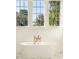 Bright bathroom featuring a soaking tub and large windows at 515 Claret Way, Kiawah Island, SC 29455