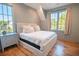 Bright bedroom features natural light, wood floors, and neutral decor for a serene setting at 515 Claret Way, Kiawah Island, SC 29455