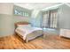 Bedroom with wood floors, neutral walls, white ceiling, and a rattan bed frame at 515 Claret Way, Kiawah Island, SC 29455